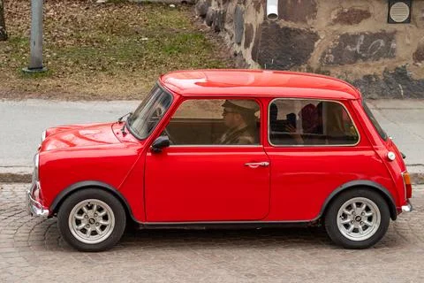 Retro car Mini drives down the street. Stock Photos