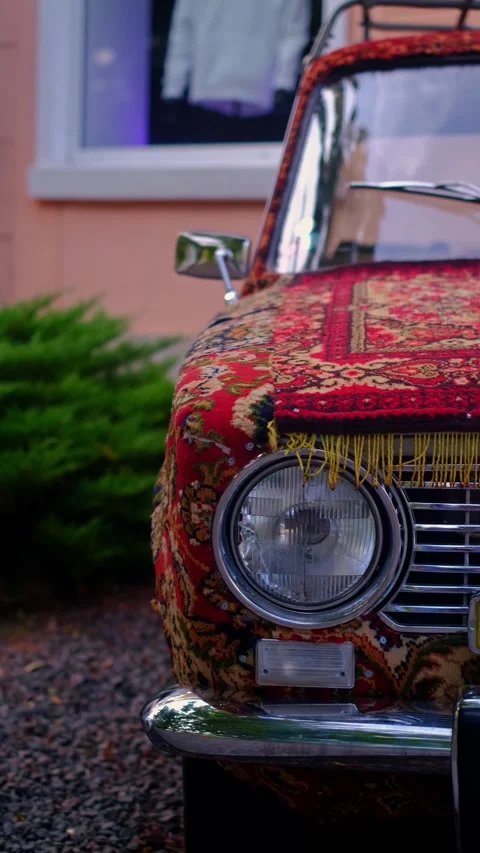 Retro car parked outside a store, showcasing tips for restoring and maintaining Stock Footage 280186427