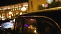 Retro car parked on Republic Square at night, reflection of Post Office Building HD Footage