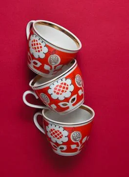 Retro ceramic stack of cups on red background. Top view 写真素材