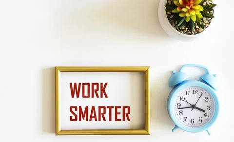 Retro clock and gold frame with text WORKS Smarter. Flower in a pot on a whit Stock Photos