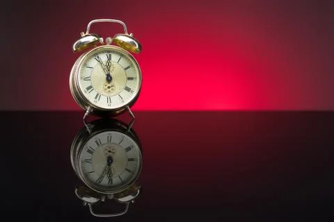 Retro clock, five to twelve, red background Stock Photos