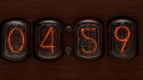 Retro clock showing 04.59 changing to 05.00 o'clock. Alarm clock at 5 a.m. - Stock Footage 217376393