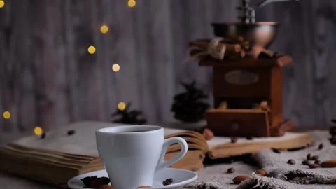 Retro coffee grinder, cup of coffee and old book on a wooden background. Stock Footage 129363992