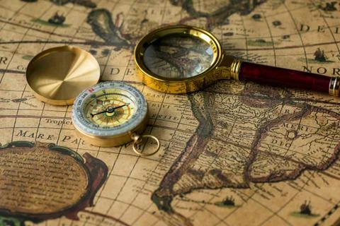 Retro compass with old map and magnifier Fotos de archivo
