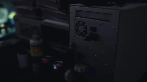 Retro computer setup with tools and containers in a dimly lit workshop Stock Footage 294996798