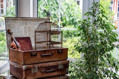 Retro decorative elements in interior. old suitcases, cell and violin. Stock Photos