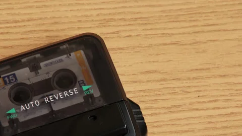 Retro dictaphone with microcassette tape on light wooden background. Stock Footage 335689623