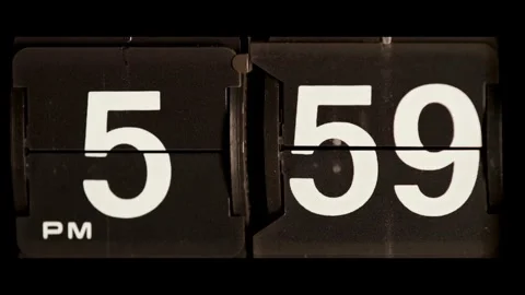 Retro flip clock changes time from 5 59 pm Video stock 329667598