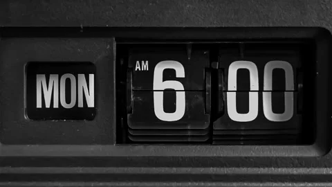 Retro flip clock changing from 5:59am to 6:00am on a Monday morning Stock Footage 145824736