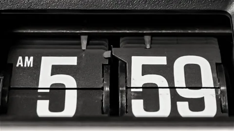 Retro flip clock changing from 5:59am to 6:00am on a Monday morning Stock Footage 145882186