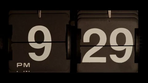 Retro flip clock changing from nine twenty nine pm Stock Footage 329667706