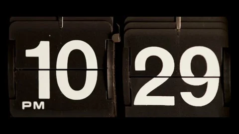Retro flip clock changing from ten twenty nine pm Stock Footage 329667704