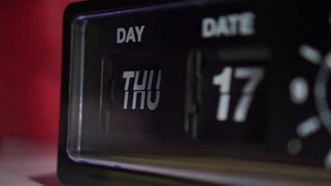 Retro flip clock date card mid-rotation, mechanical day date display close-up. Stock Footage 345871143