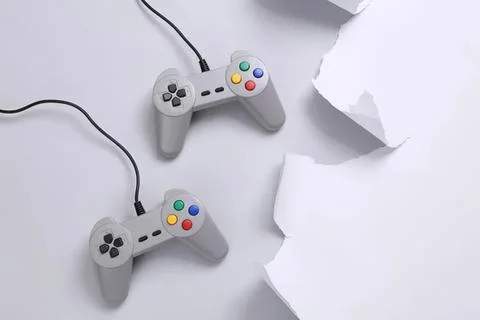 Retro gaming controllers connected with cables on white background Stock Photos