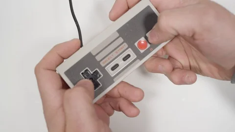 Retro gaming playing with controller video games Stock Footage 88332545