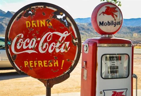 Retro gas pump and a rusty coca-cola sign on historic route 66 Stock Photos