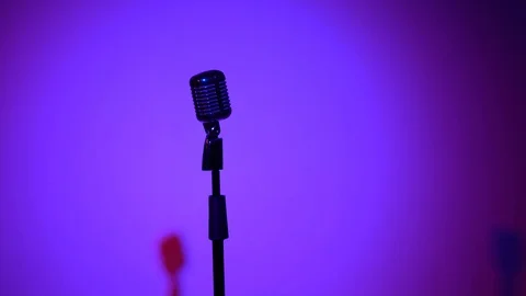 Retro glare microphone on stage in dark room. Blue color from spotlight. Stock Footage 118527342
