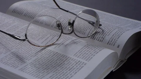 Retro glasses on the book.  The movement of the camera dolly. Stock Footage 73462088