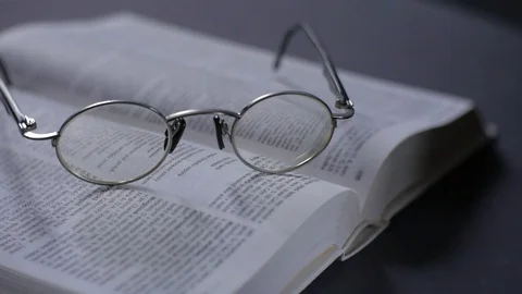 Retro glasses on the book.  The movement of the camera dolly. Stock Footage 73462103