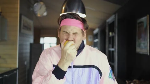 Retro guy freak eating lemon whole Stock Footage 143011886
