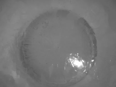 Retro image - Close view on circle in transparent ice formed around dense white Stock Photos
