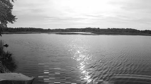 Retro image - Light damaged image of pond in summer under partly cloudy sky. Stock Photos