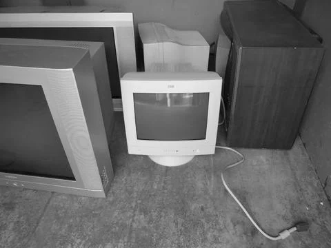 Retro image - Multiple old computer monitors and TVs inside of electric waste Stock Photos