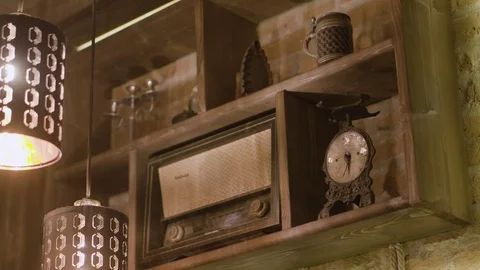 Retro interior design inside a bar. Outdated vintage objects. Radio, clock 库存影片 121097608