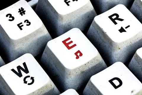 Retro Keyboard with E button in red color. E button keyboard in close up macr Stock Photos