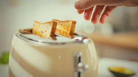 In a retro kitchen a vintage toaster pops a slice of bread into crisp toast Stock Footage 335462616