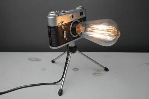 Retro lamp from an old camera with an Edison lamp. Concept is a good idea. Stock Photos