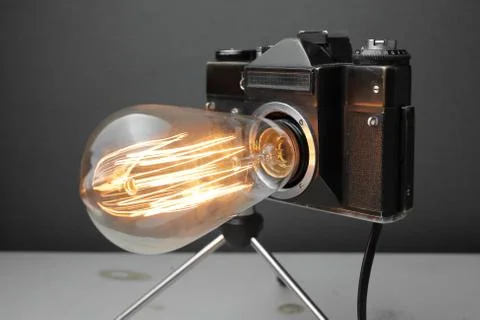 Retro lamp from an old camera with an Edison lamp. Concept is a good idea. Stock Photos