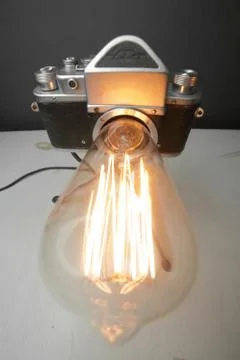 Retro lamp from an old camera with an Edison lamp. Concept is a good idea. Stock Photos