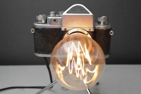 Retro lamp from an old camera with an Edison lamp. Concept is a good idea. Stock Photos