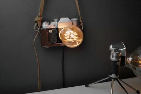 Retro lamp from an old camera with an Edison lamp. Concept is a good idea. Stock Photos