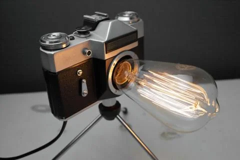 Retro lamp from an old camera with an Edison lamp. Concept is a good idea. Stock Photos