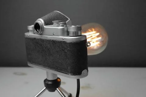 Retro lamp from an old camera with an Edison lamp. Concept is a good idea. Stock Photos