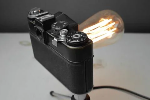Retro lamp from an old camera with an Edison lamp. Concept is a good idea. Stock Photos
