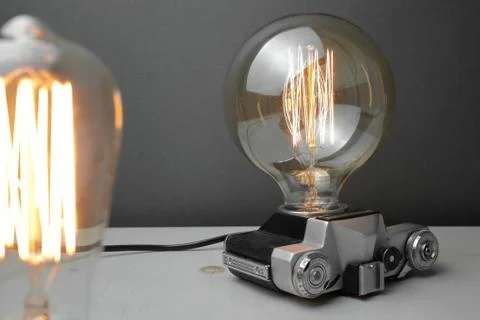 Retro lamp from an old camera with an Edison lamp. Concept is a good idea. Stock Photos