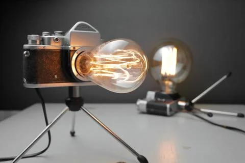Retro lamp from an old camera with an Edison lamp. Concept is a good idea. Stock Photos