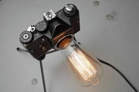 Retro lamp from an old camera with an Edison lamp. Concept is a good idea. Stock Photos