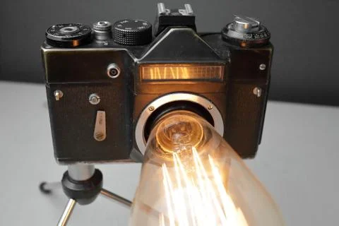 Retro lamp from an old camera with an Edison lamp. Concept is a good idea. Stock Photos