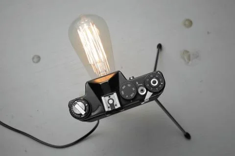 Retro lamp from an old camera with an Edison lamp. Concept is a good idea. Stock Photos