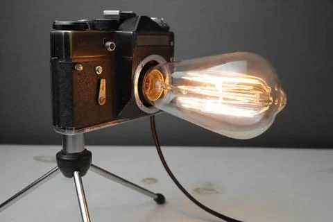 Retro lamp from an old camera with an Edison lamp. Concept is a good idea. Stock Photos