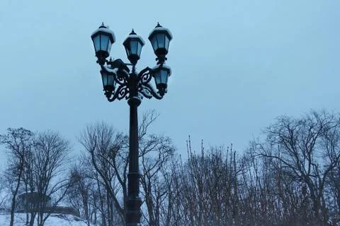 Retro lantern in winter park Stock Photos