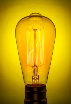 Retro light bulb. The glowing electrodes. Vintage Edison lamp. Stock Photos