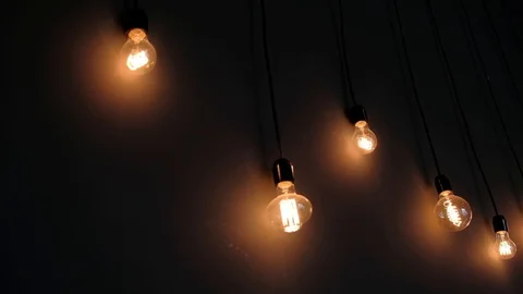 Retro light bulbs of the Edison, on dark wall, loft design Stock Footage 129085051