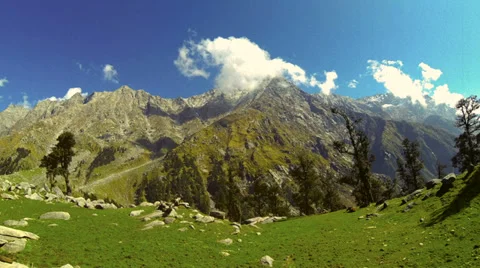 Retro look time lapse clouds running above Himalayan mountain peak in sunny day. Stock Footage 37713106