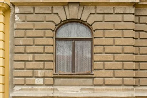 Retro looking window on a brown facade Stock Photos